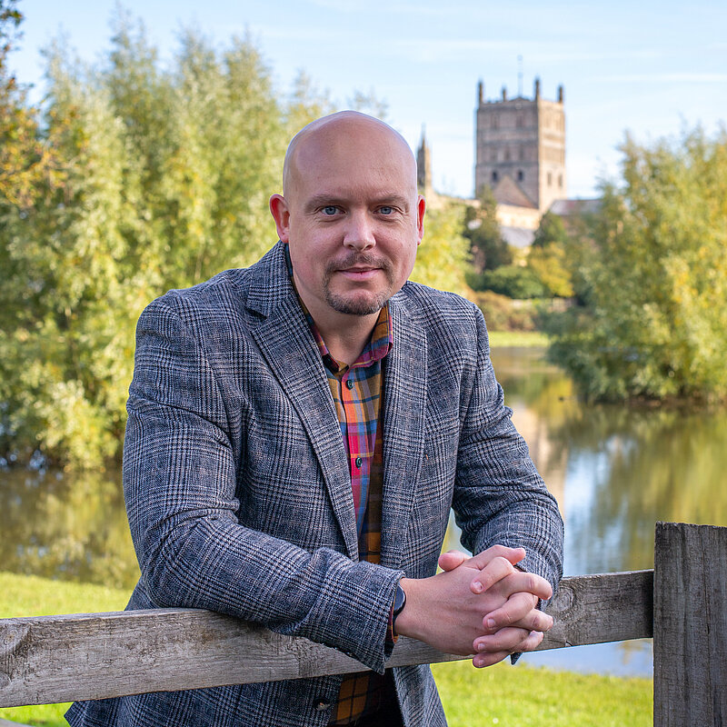 Cameron Thomas in front of Tewkesbury Abbey
